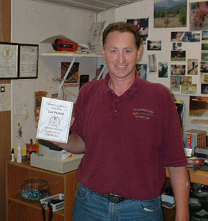 photo of Bill displaying his 1st-place trophy