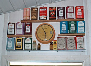 photo of shelves above shop door, displaying antique gunpowder tins